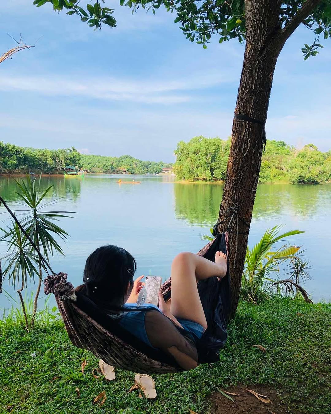 Guest relaxing in hammock with lake view